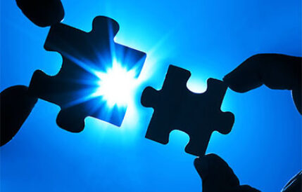 Two Puzzle Pieces Two puzzle pieces fitting together with glowing light behind them