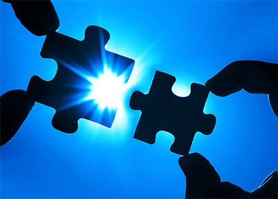 Two Puzzle Pieces Two puzzle pieces fitting together with glowing light behind them