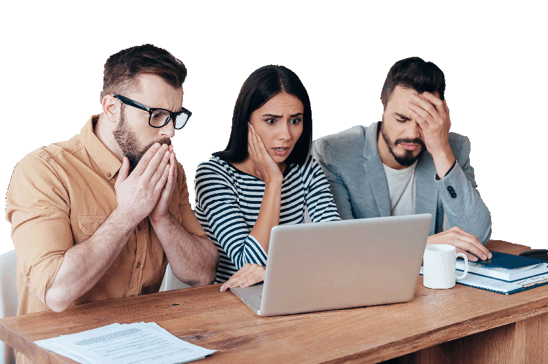 Three employees looking upset at computer over mistake made